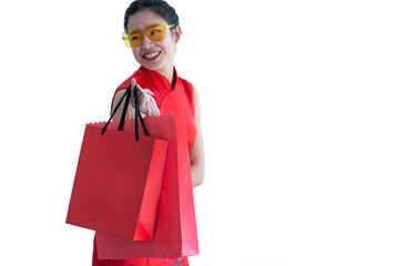 Smiling young woman in Chinese traditional dress looking to the right, holding red shopping bags, with clipping path
