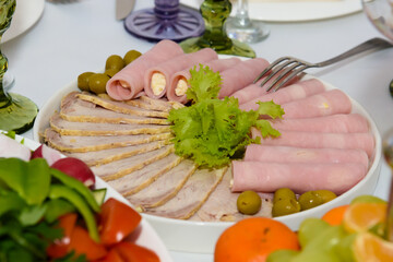 Meat snacks on the festive table. Reception of people in the restaurant.
