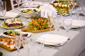 Snacks and dishes on the festive table. Reception of a large number of people in the restaurant.