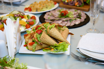 Snacks and dishes on the festive table. Reception of a large number of people in the restaurant.