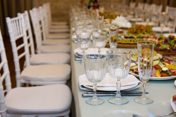 Banquet table served for guests. Cutlery and food at the reception party.