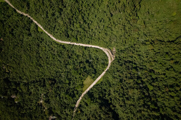 Top down view in Teresópolis of meandering road through rainforest mountainous vegetation in Rio de Janeiro Atlantic woods. Adventure hiking and outdoor sports in Brazil.