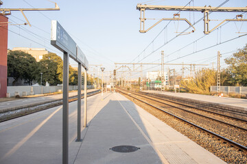 Railway station Castelldefels. Rail travel. Modern intercity train on a railway platform. Passenger train on the railway in the evening.
