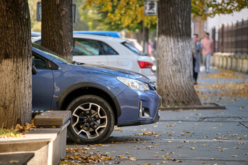 Close up of a car parked illegally against traffic rules on pedestrian city street side