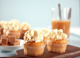 Homemade cupcakes with caramel syrup and whipped cream cheese