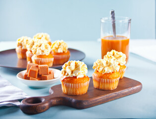 Homemade cupcakes with caramel syrup and whipped cream cheese