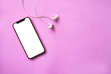 Blank screen smartphone with earphones on pink background