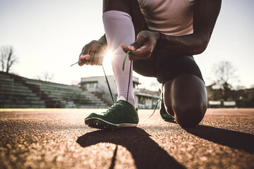 Closeup of man trying jogging shoes - Male athlete run on running track in a stadium - Sport...