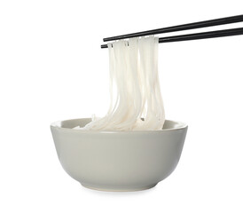 Chopsticks with cooked rice noodles over bowl isolated on white