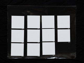 real macro photo of black and white hand copy contact sheet with 11 empty film frames. 120mm medium...