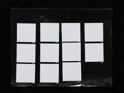 real macro photo of black and white hand copy contact sheet with 11 empty film frames. 120mm medium format film photo placeholder.