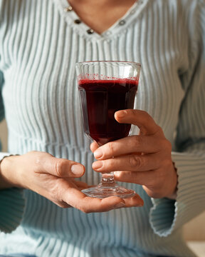 Woman Holding A Cup Of Fresh Homemade Red Beetroot Juice