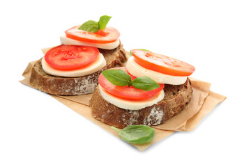 Delicious sandwiches with mozzarella, fresh tomatoes and basil on white background