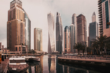 Fototapeta na wymiar DUBAI, UAE - FEBRUARY 2018: View of modern skyscrapers shining in sunrise lights in Dubai Marina in Dubai, UAE.