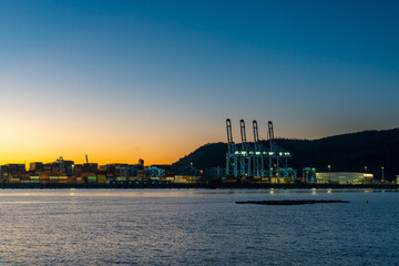 Obraz premium view of the industrial port and harbor of Vado Ligure at sunrise