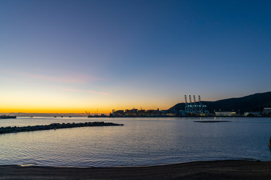 view of the industrial port and harbor of Vado Ligure at sunrise