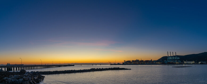view of the industrial port and harbor of Vado Ligure at sunrise