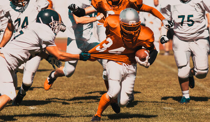 american football players fighting for the ball
