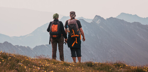 hiker couple enjoying high mountains view