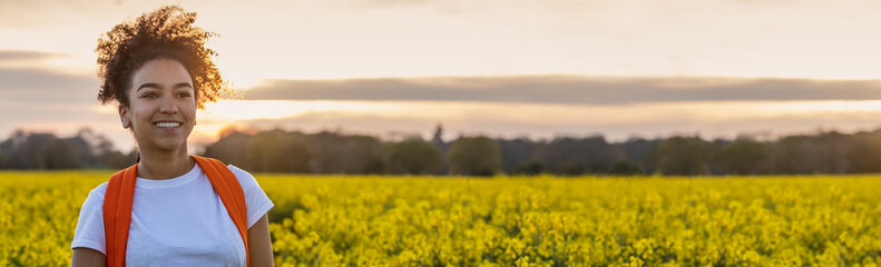 African American Teenager Woman Hiking in Yellow Flowers Panorama Web Banner Header