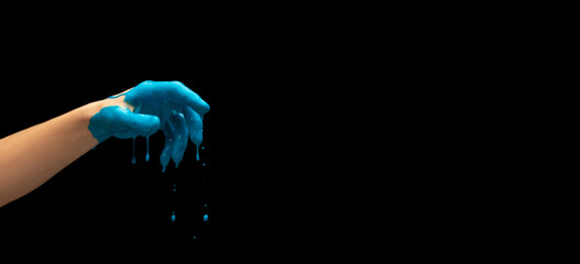 Male hand painted blue gesturing isolated on dark studio background. Concept of human relation,...