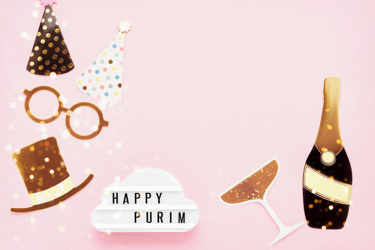Jewish holiday Purim concept. Fun party props and lightbox with Happy Purim on a pink background