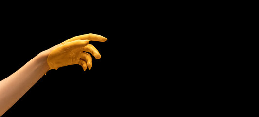 Flyer with painted human hand gesturing isolated on black studio background. Concept of human...