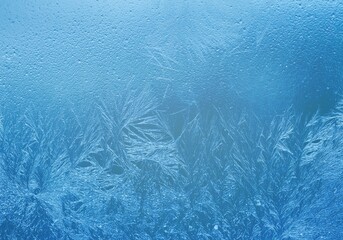 Abstract frosty pattern on glass, blue background texture.