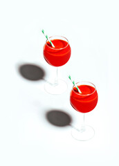 close-up of two glasses with a red cocktail with a straw on a white background