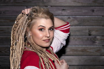 Fototapeta premium pretty blonde woman with dreadlocks touching her hair