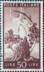 Italy - circa 1945: a postage stamp from Italy showing a Tree in bloom and Italian goddess