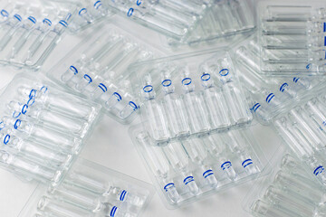 plastic transparent containers with glass ampoules on a white background