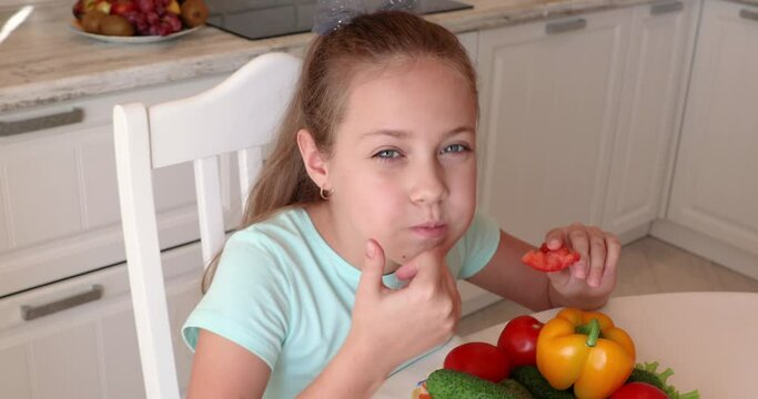 the child eats vegetables with pleasure. The girl eats healthy food. the concept of children's health
