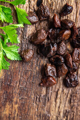 black olives pitted dried fruit smoked flavor healthy meal food snack on the table copy space food background rustic top view