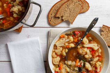 Cauliflower soup with eggplant and other vegetables. Vegan dish. 