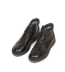 Men black winter leather boots with fur inside isolated on white background