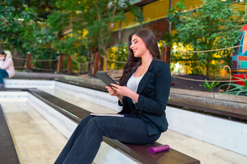 Fototapeta premium Young attractive student using a digital tablet indoor