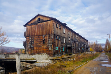 Fototapeta na wymiar Old abandoned three-story house in the north of the Amur region