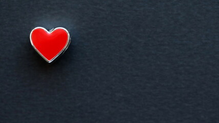 Red heart isolated on black background. Top view, flat lay. Space for text.