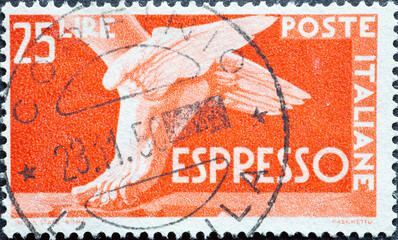 Italy - circa 1947: a postage stamp from Italy showing a winged foot from mythology