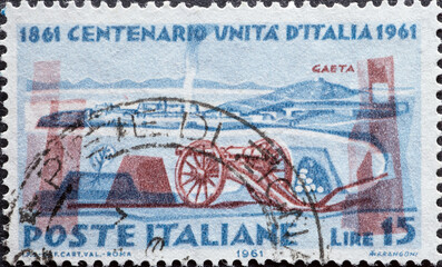 Italy - circa 1961: a postage stamp from Italy showing some Cannon and the fortress of Gaeta