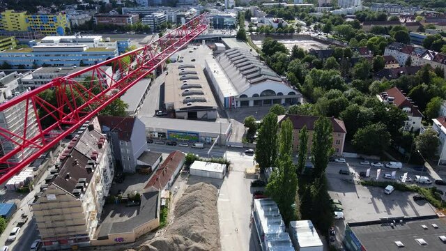 Tower crane at construction site, building yard, Aerial drone shot in 4k, urban suburban Germany
