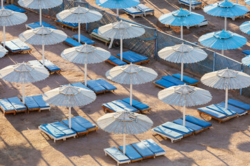 Egypt. Sharm el-Sheikh. Beach umbrellas from the sun and sun loungers on the beach.