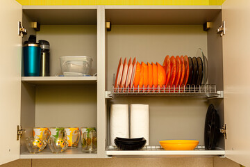 kitchen utensils and utensils are on the shelf of the kitchen cabinet