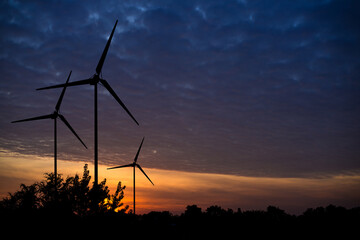 Offshore wind turbines farm At sunrise.