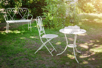 Coffee table with tea pot and teacup on wooden tray in the garden. Tea time.