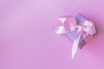 gift box with bow on pink background. Flat lay, top view, copy space.. Flat lay, top view, copy space.