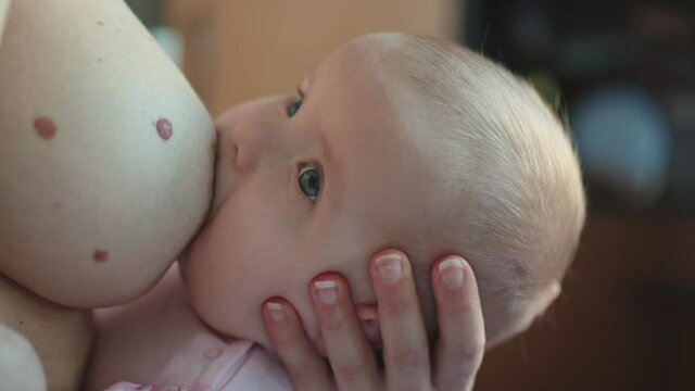 Woman breastfeeding newborn baby. Concept breast feeding. Baby eating mother's milk.