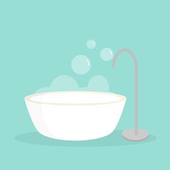 Freestanding bathtub with bubbles on blue bathroom wall background. Hygiene interior design body skin care concept