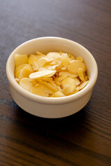 small bowl with filleted almonds close up